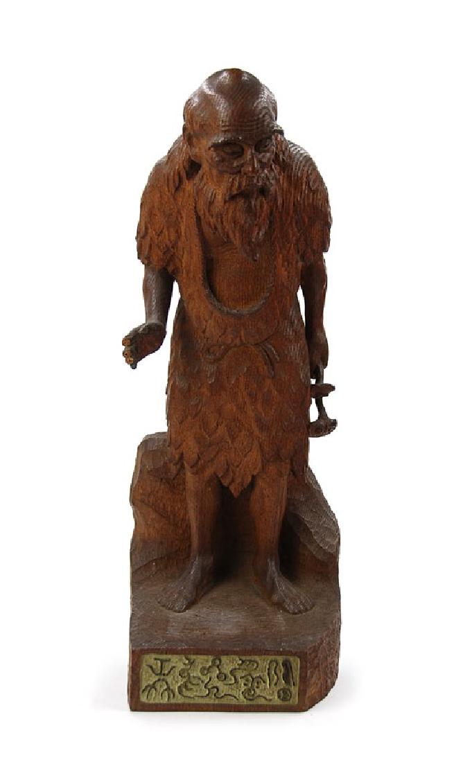 A JAPANESE CARVED WOOD FIGURE; EDO DYNASTY(1603-1867): Carved wood figure stand on base with character, missing fingers. H:18 1/4in (46.4 cm) W:6 1/2in (16.5 cm)