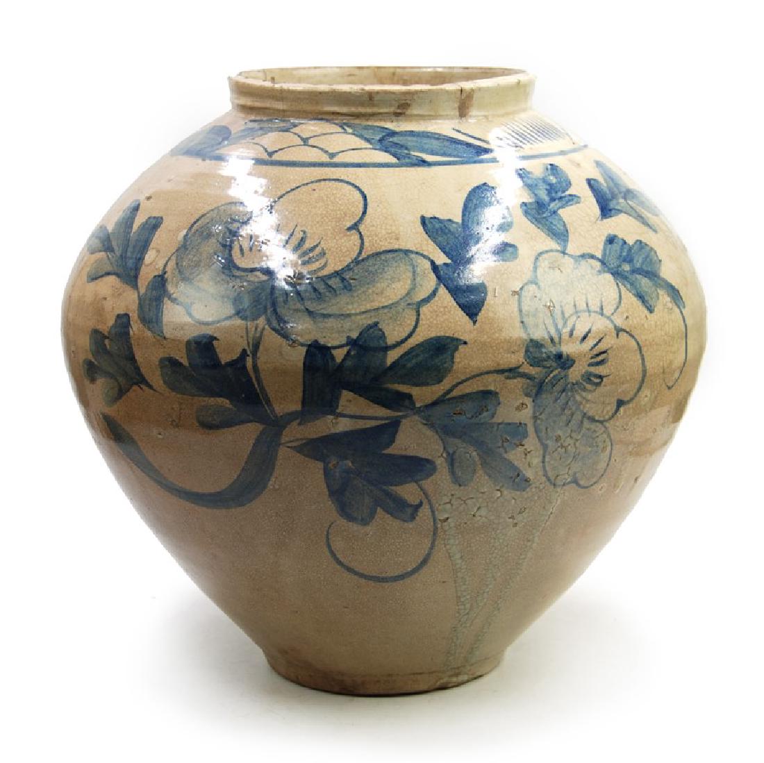 KOREAN MOON JAR BLUE DETAIL: A glazed jar decorated with blue flowers. H:12 1/2in (31.7 cm) W:13in (33.1 cm) M:5 1/2in (13.9cm)