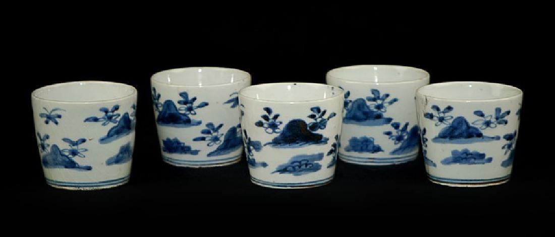 SOBA CUPS; EDO PERIOD (1603-1867): A group of 5 blue and white soba cups decorated with mountain and flower patterns. H:2 1/4in(5.6cm) D:2 3/4in(7cm)