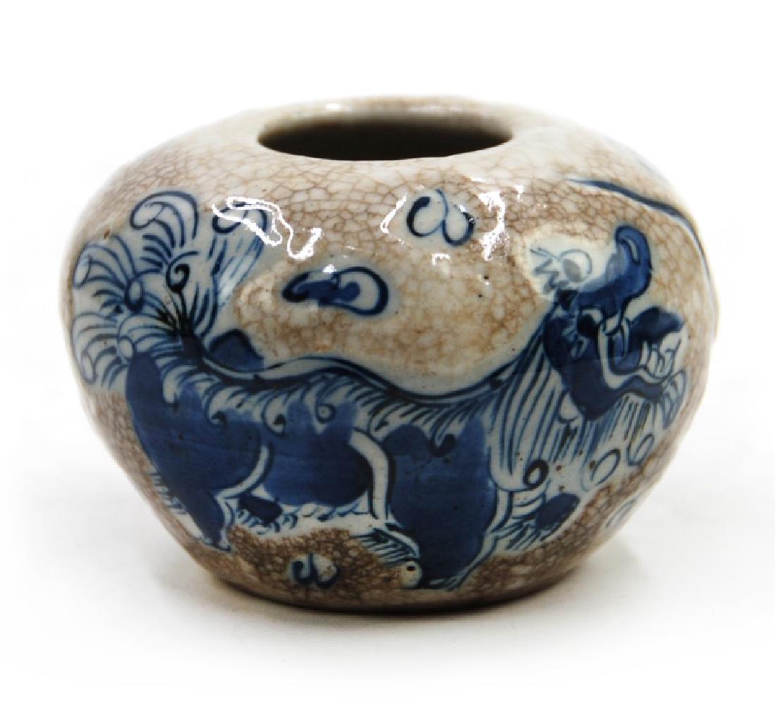 A CHINESE BLUE AND WHITE BRUSH DIPPER, QING DYNASTY: A Small blue and white brush dipper decorated with beasts,H:2in (5.1 cm) W:2 3/4in (6.9 cm) M:7/8in (2.2 cm)