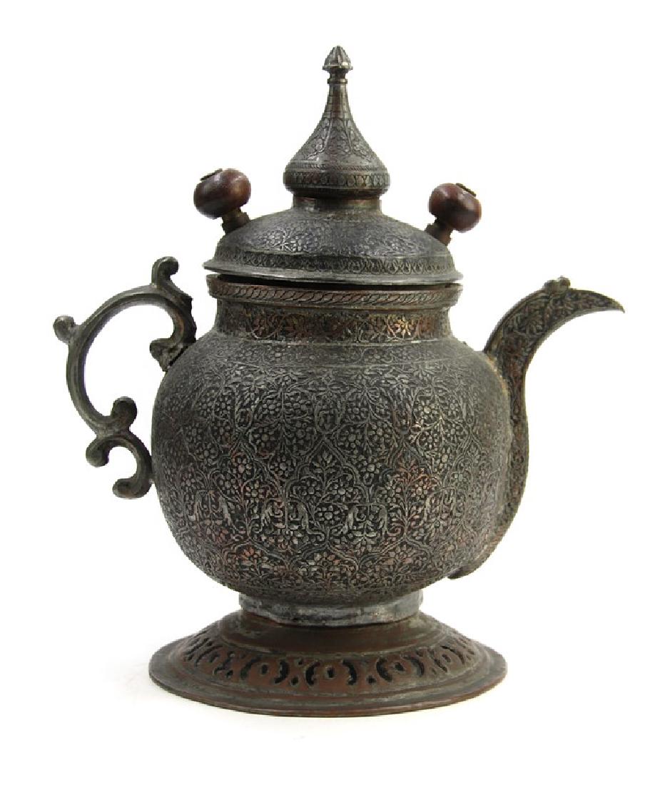 INDONESIAN TEA KETTLE: A bronze tea pot decorated with flower patterns. H:9 3/4in (24.7 cm) W:9in (22.8 cm)