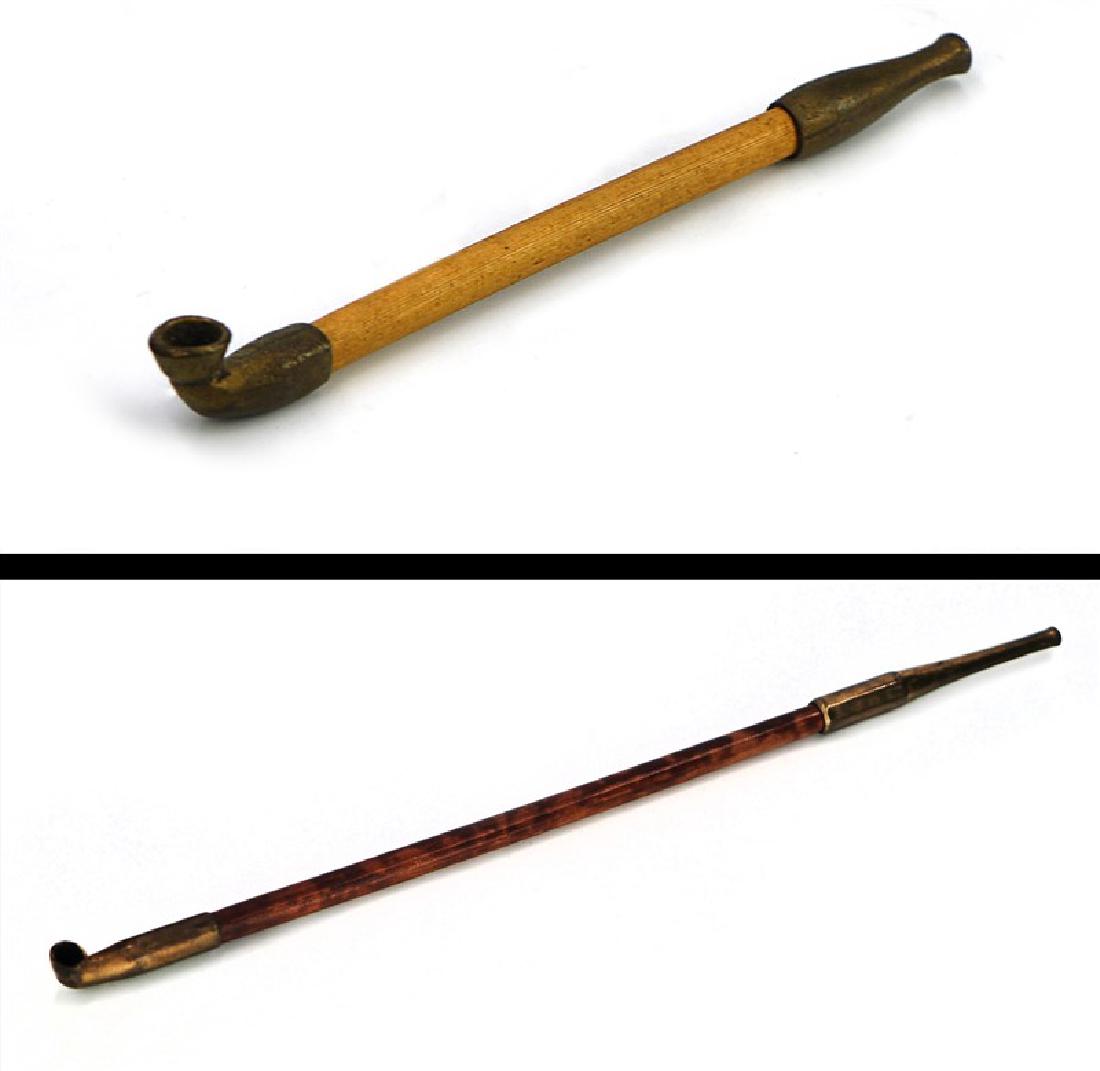 BRONZE BAMBOO PIPE PAIR: A pair of long pipes, one has a lighter yellow body, and the other has darker body. L:5 7/8in (15cm ) L:13 1/2in (34.4cm)