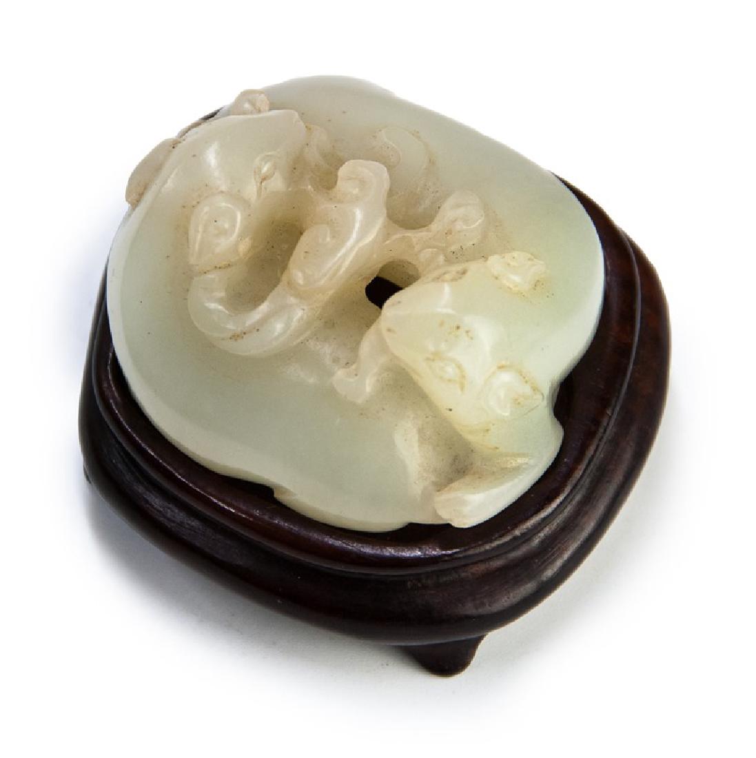 HETIAN JADE DUAL BADGER TOGGLE; QING DYNASTY: A milky white jade toggle carved into dual badgers facing each other with a sprig of Lingzhi mushroom held in their mouths. _x000D_ H:3/4in(1.8cm) W:1 1/4in(3.1cm) 46g_x000D_