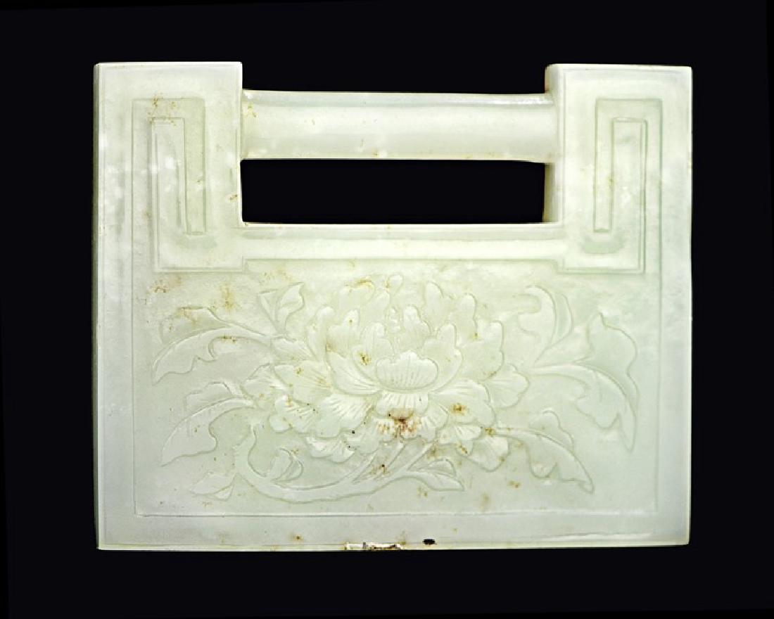 JADE CARVED LOCK PLAQUE: Given to infant boys to protect them, the front bears a peony blossom carving symbolizing wealth, and the back is carved with Chinese characters bestowing blessings of prosperity._x000D_ L:3 1/2in(8.9