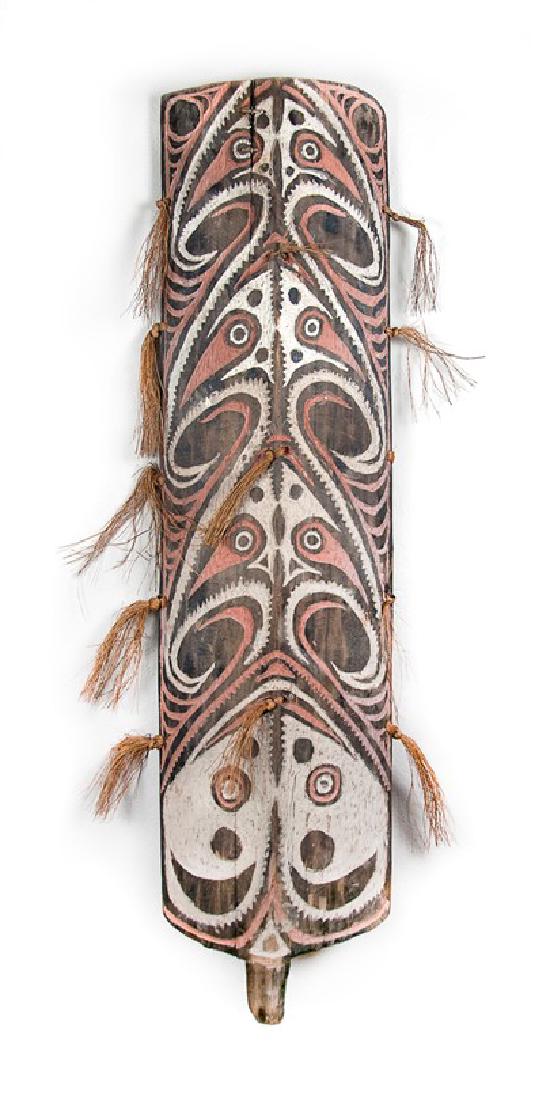 CARVED AND PAINTED WAR SHIELD; PAPUA NEW GUINEA: AGE IS OVER 95-100 YRS. OLD SEPIK WAR SHIELD. _x000D_ OCEANIA/MALANESE MIDDLE SEPTIK. NORTHEASTERN NEW GUINEA. _x000D_ CURVED WOODEN WAR AND DANCE SHIELD. _x000D_ CARVED FROM A SINGLE PIECE OF WOOD_x0
