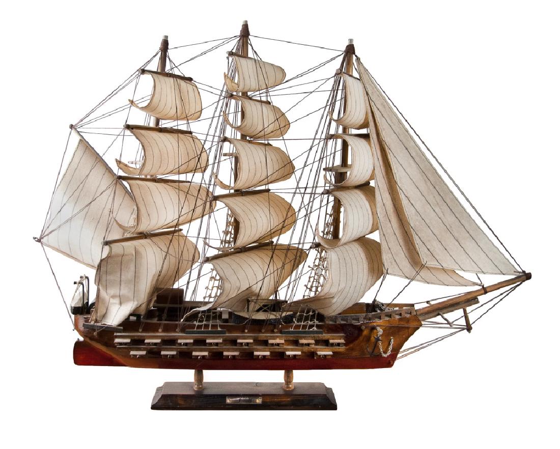 WOODEN MODEL OF A FRIGATE: A wooden frigate carved with all the gun port open._x000D_ H:22in(55.9cm) W:29in(73.7cm)_x000D_