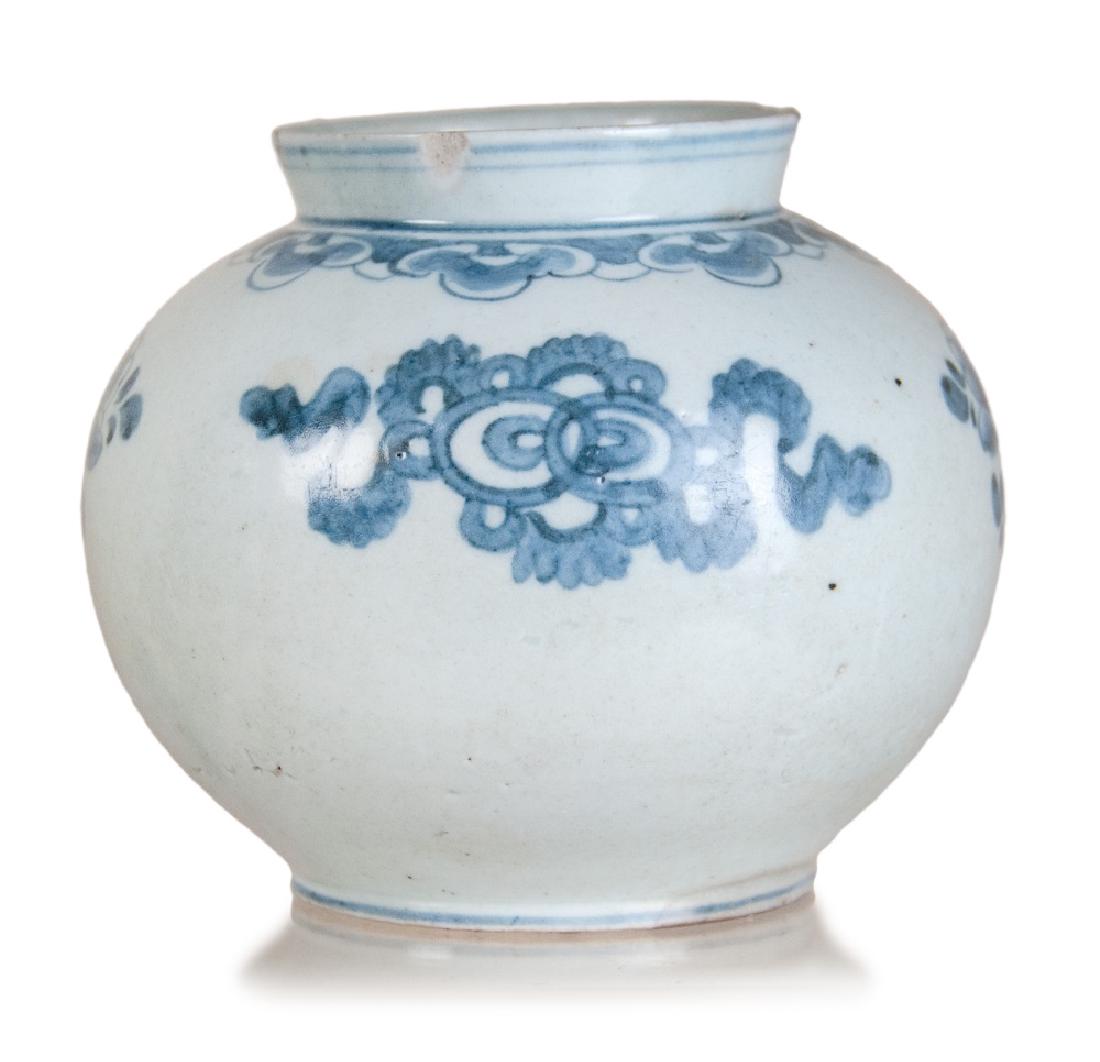 KOREAN PORCELAIN MOON JAR: A blue and white moon jar featured with a globular body, and decorated with songyun pattern on the shoulder and floral patterns on the body. H:5 1/2in(14cm) W:6in(15.2cm) M:3in(7.6cm)