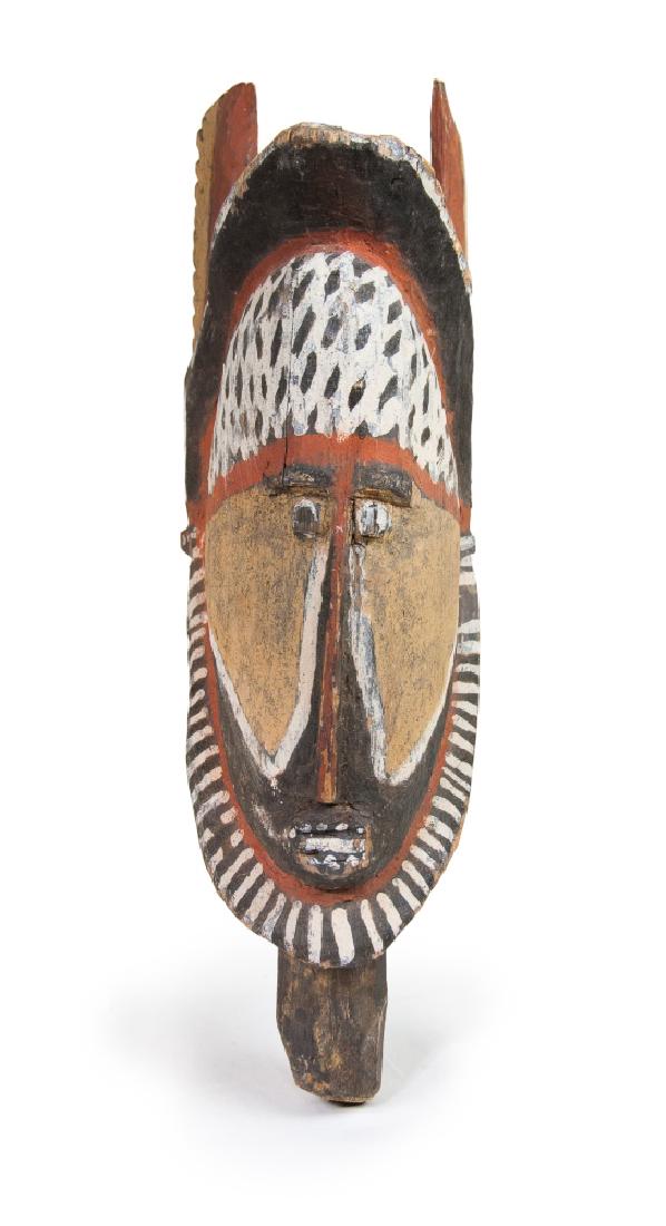 ABELAM WOODEN YAM CEREMONY MASK: This Papua New Guinea wood carved mask is painted in lime, reddish-orange and white pigments, with a white net pattern on the forehead, and carved with two wing-like parts on the back of the head. L:1