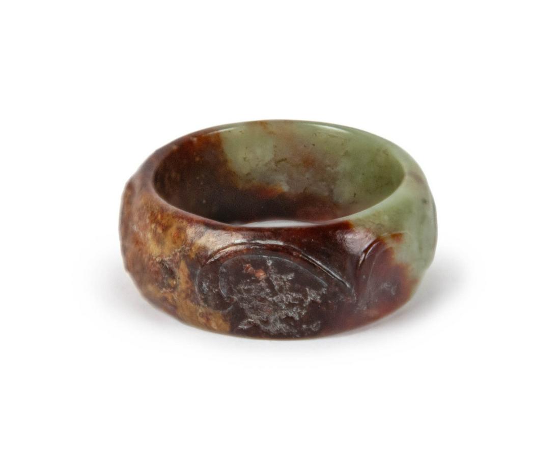 A RUSSET-BROWN JADE CARVED RING (1 of 2)