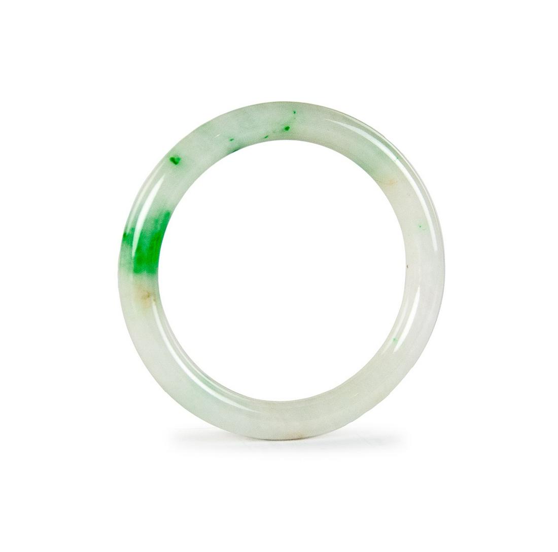 A JADEITE BANGLE: The translucent jadeite bangle of white bodycolour, suffused with bright green streaks, outer, inner diameter and thickness. 41g 2 3/8in(6cm)