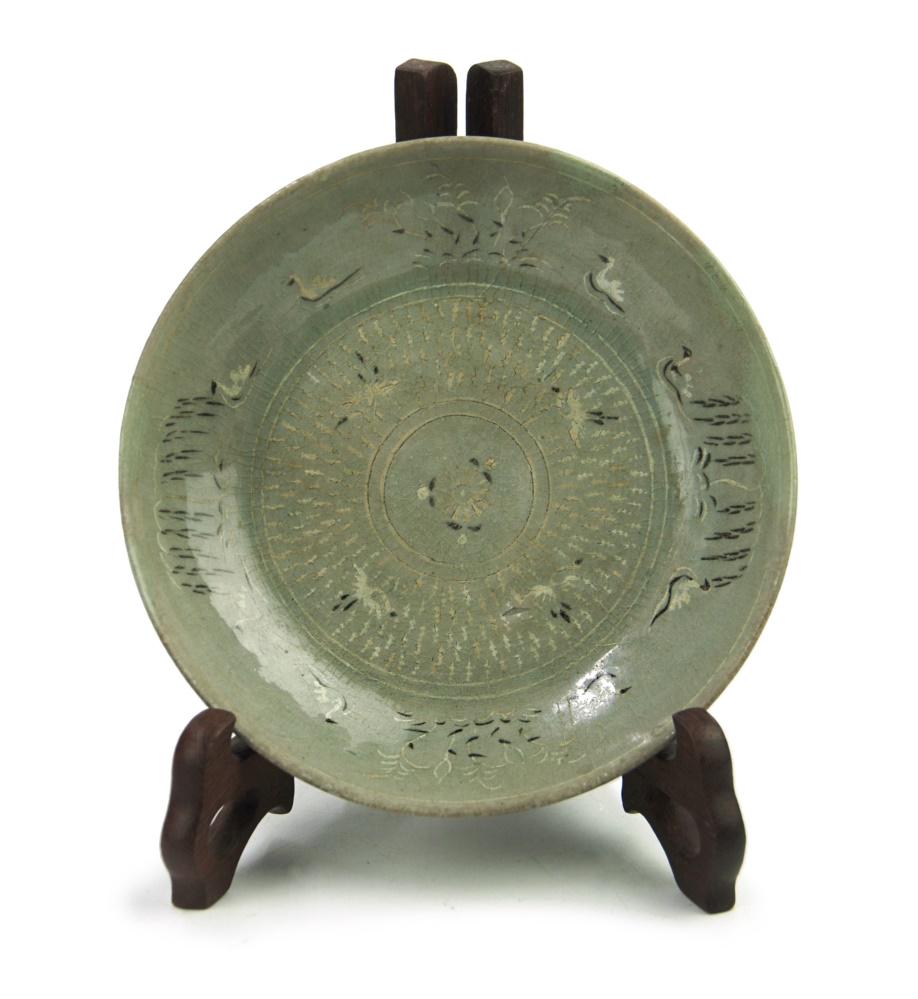 A KOREAN CELADON CRANE DISH: A Fine and Rare Korean Black and White Slip, Celadon dish. Decorated in black and white slip on the interior with willow trees and cranes. Has had professional repair work done on the rims. Stand is n