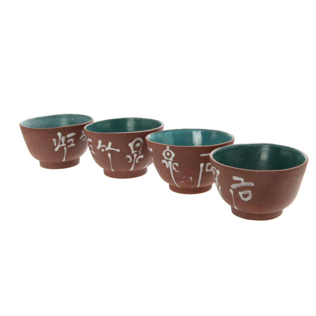 GROUP OF FOUR YIXING TEA CUPS: H:1 5/8in(4.1cm) D:2 3/4in(6.9cm)