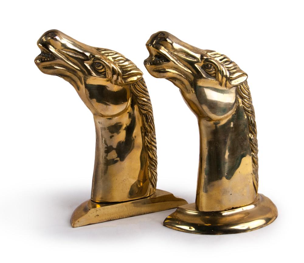 HORSE HEAD BOOKENDS: A pair of metal gold-toned horse head book ends. H:7 1/2in(19cm) W:6in(15.2cm)