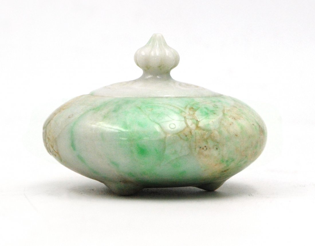 JADE INCENSE BURNER: Of flattened rounded form, this polished burner bears etched butterfly designs along the sides and openwork spade designs on the lid, with a pomegranate finial and three feet, the stone is a creamy wh