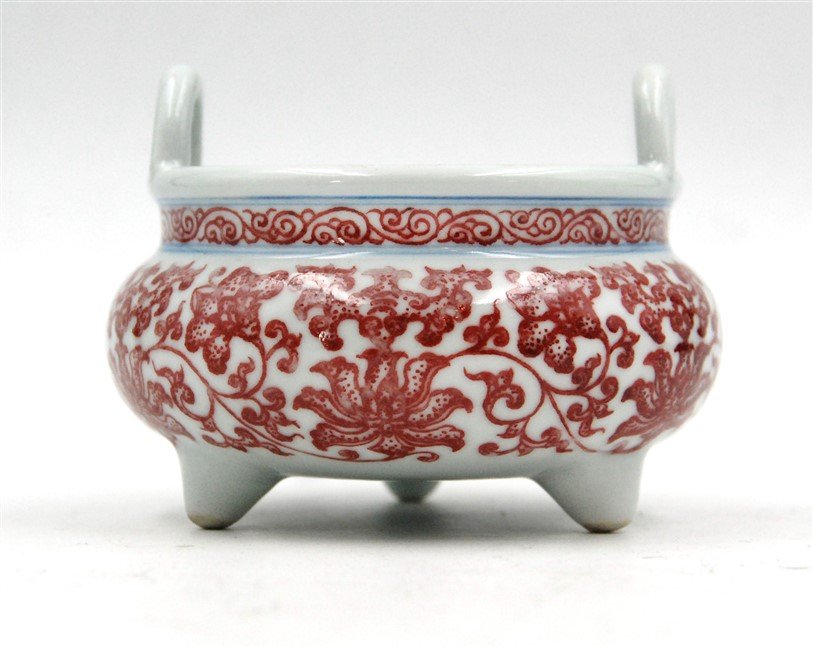FLORAL PORCLEAIN INCENSE BURNER: Evenly glazed in white and painted with red flowers and leaves, this incense burner bears a Qianlong six-character mark. H:3 W:4