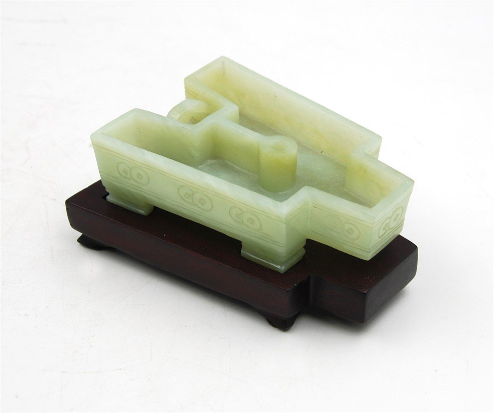 JADE INCENSE BURNER: Carved jade incense burner in the shape of ancient Chinese knife money; with a wood stand H: 3 3/4