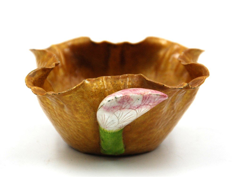 GOLDEN TONED LOTUS BOWL: A light copper glazed bowl imitating an organic shape of the natural folds of a leaf, with a lotus bud attached to it. L: 5 W: 5 H: 2.5
