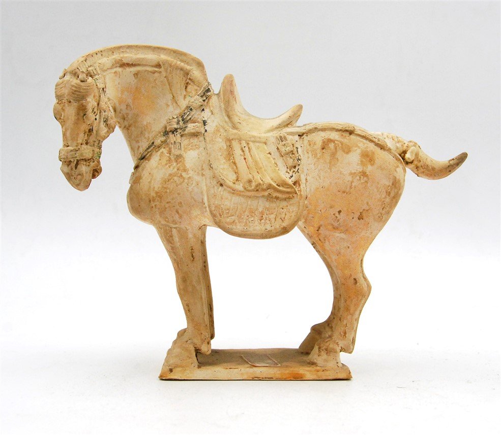 HAN DYNASTY CLAY PAINTED HORSE: Outfitted with a saddle, this clay horse shows traces of decorative paint. L:9 H:8