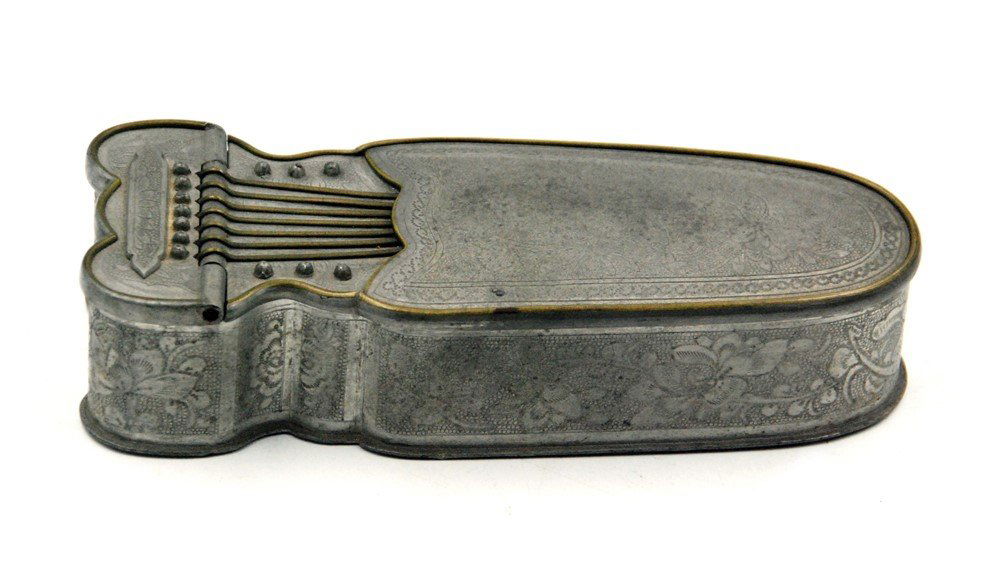 CHINESE PEWTER MAKEUP KIT: Shaped as a string musical instrument, this makeup box has a mirror installed on the underside of the lid and three compartments. Has three seals on the bottom, from left to right: "One price right,"