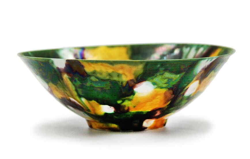 SPINACH AND EGG GLAZED BOWL: A bowl covered in the 'spinach and egg' glaze. Decorated with irregular overlapping yellow, green, brown and cream splashes throughout interior and exterior. D: 8 H: 2 ¾