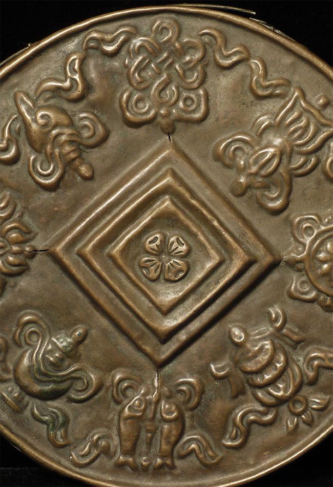 Stylized Antique Mongolian Copper Mandala. Used to: Stylized Antique Mongolian Copper Mandala. Used to meditate on the freedom of suffering for all sentient beings. Diameter is 5"