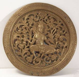 Interesting Indian figure sculpted into a coppper: Interesting Indian figure sculpted into a coppper plate. Has age to it. About 6" in diameter.