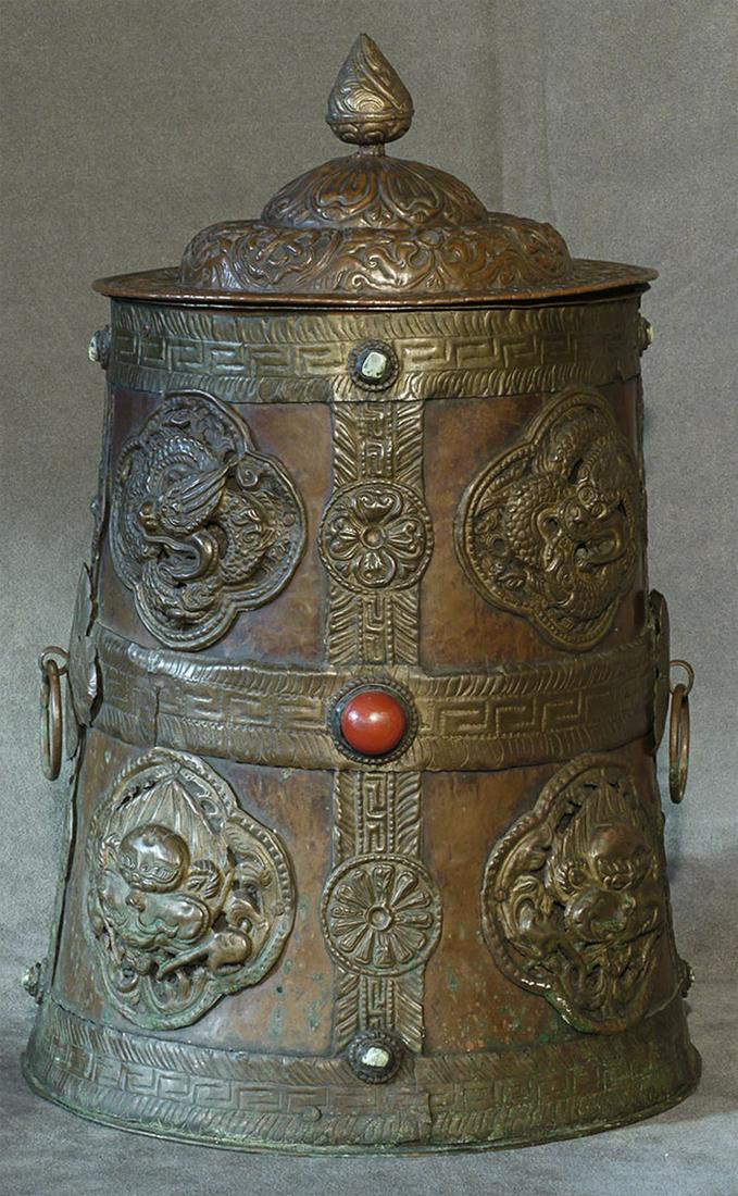 Very large Tibetan or Nepalese container with 8: Very large Tibetan or Nepalese container with 8 auspicious symbols done in copper repousse. A few missing stones and the handle on the top is a bit loose, but excellent overall. Total height is 14.75 