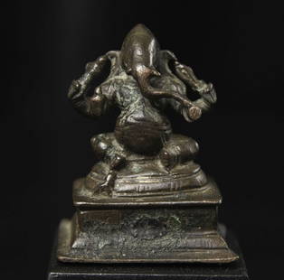 Classic 18-19thC near miniature Indian bronze four-arm Ganesh.: Classic 18-19thC near miniature Indian bronze four-arm Ganesh with significant ritual wear. Hard to find such a classic example in this diminutive size. Sits 1 and 5/8" tall and 2.75" on its custom ba
