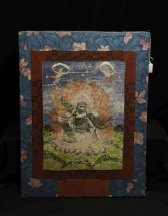 18/19thC Tibetan Thangka of a fierce deity. Actual: 18/19thC Tibetan Thangka of a fierce deity. Actual image is 14.5" x 12". Framed within other fabric, then stretched over a frame that is 25.25" x 19.25". Wear as seen in photos.