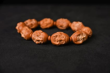 This is a set of 12 very finely carved Buddhist monk heads in canarium seed pits from China.