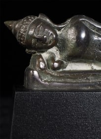 Antique Burmese lead/bronze Buddha in an Ava style, in a reclining position on a custom base.