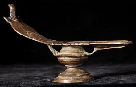 Antique Asian oil lamp. Looks to be missing a part at one end. Measures 10 7/8" long