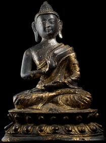 Tibetan Buddha with remains of gilding. Unusual ripples