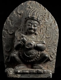 Antique Tibetan Mahakala standing on a victim. Sandstone or composite material