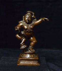 Antique bronze. 4.25" tall, base measures approximately