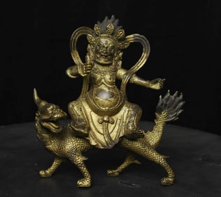 Fierce Tibetan bronze Deity on Dragon.