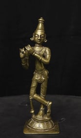 Antique bronze Folk style Krishna playing his flute.