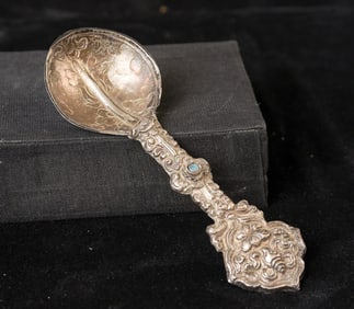 Indian handcrafted silver anointing spoon with in laid stone.