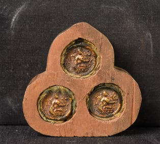 Three small old Mongolian tsa tsa's in a very provincial recent wooden gau.