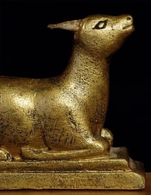 Pair of vintage "wood" Mongolian deer flanking a wheel of the law.