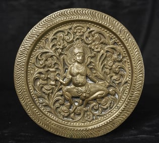 Antique Indian figure sculpted into a pierced copper plate.