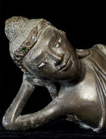 19thC solid-cast reclining Burmese Buddha.