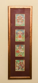 A set of 4 antique Mongolian Thangkas in a custom vertical frame.