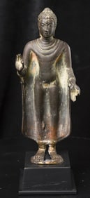 A Thai bronze standing figure of Buddha in 8th/9th century style.