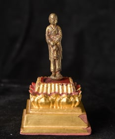 Tang or later bronze Monk with vase with remains of rich gilding.