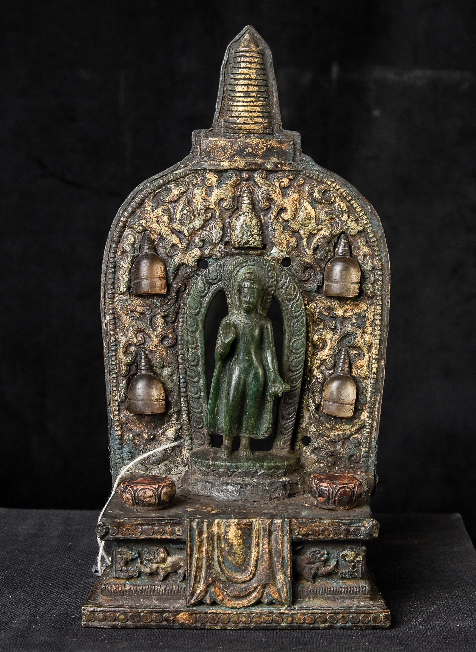 17th-19thC Glass Buddha with Gilt-Copper Mandorla & Crystal Stupas: A Glass Figure of Buddha Shakyamuni with an Inlaid Gilt-Copper Mandorla, Nepal, 19th Century or Earlier (Base & Mandorla 17th Century) A finely assembled devotional shrine featuring a rare glass figur
