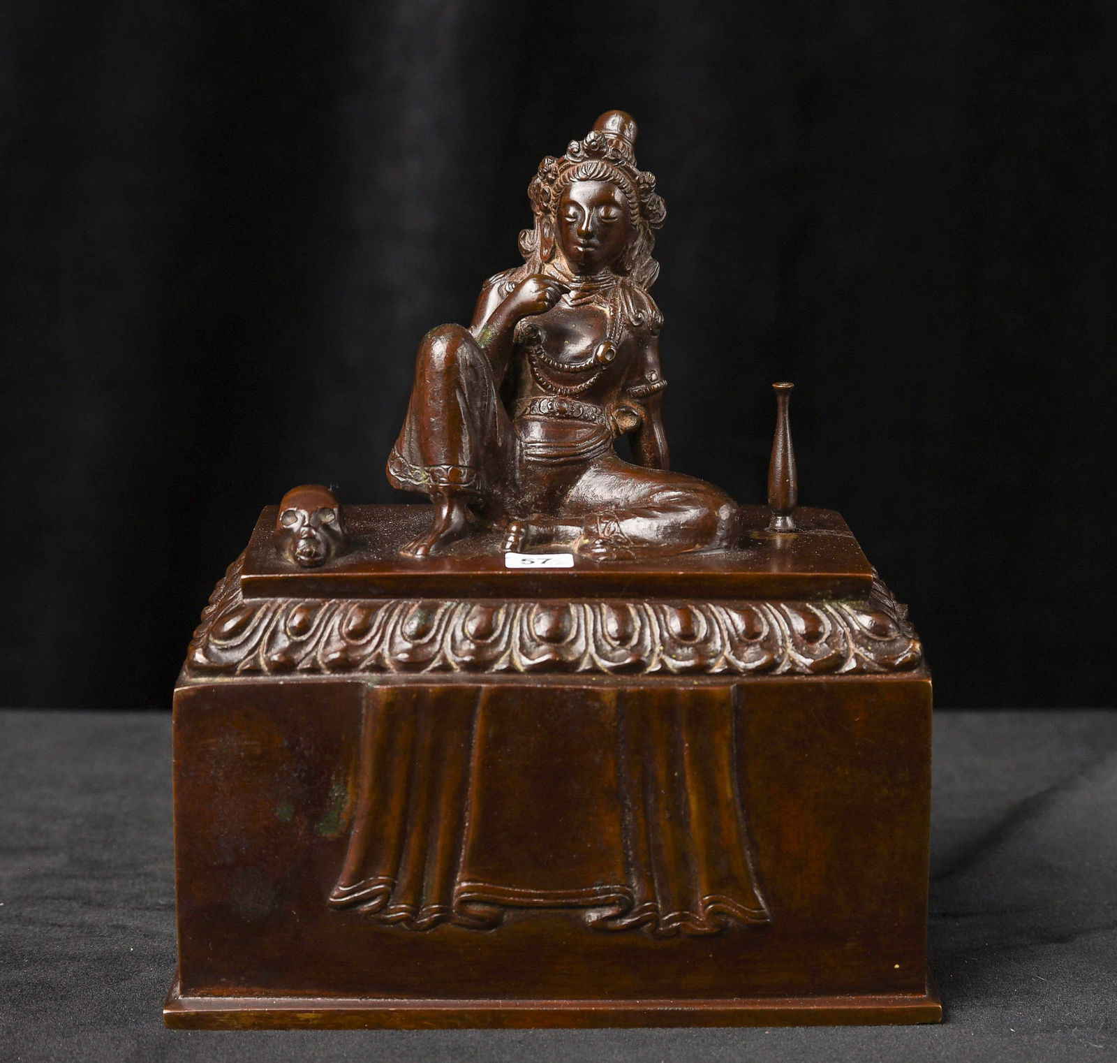 Antique Buddhist Tantric Bronze Box from Tibet or Laos: Remarkable antique Buddhist tantric bronze box from Tibet or Laos, featuring an exceptionally rare and complex iconography. The cover shows a relaxed seated female figure flanked by a skull and a vase