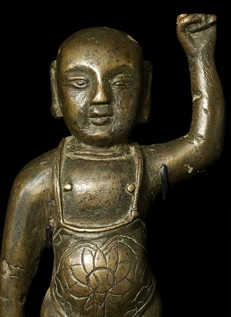 15/16thC Ming Baby Buddha, High Silver Content: 15/16thC Ming Baby Buddha. Alloy appears to have high silver content. Missing both pointing fingers, which is common in this form. Evidence of an attempted repair on the upraised hand. Very sweet fell