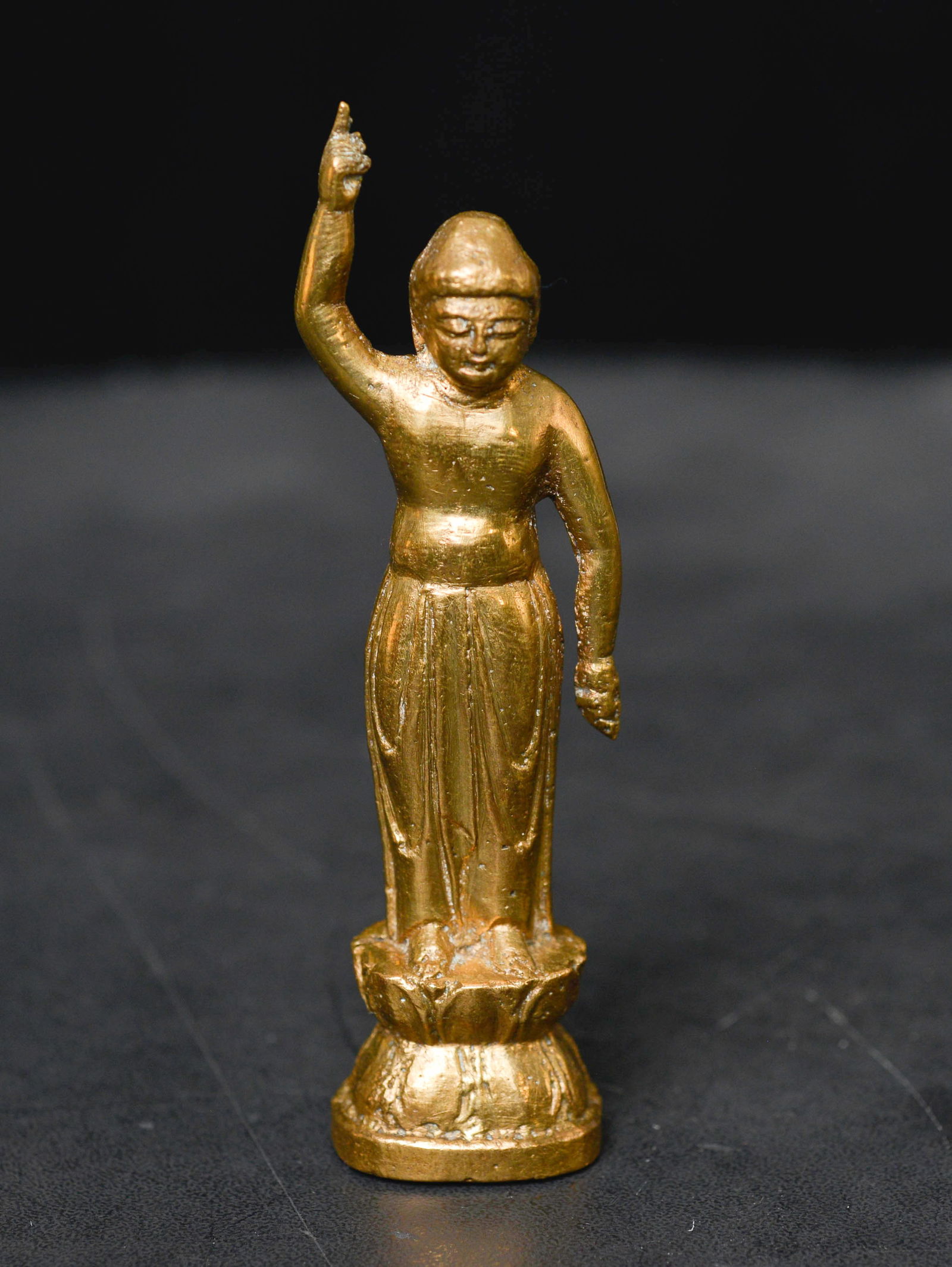 Japanese Early Edo period or earlier (15thC) Baby Buddha.: Japanese Early Edo period or earlier (15thC) Baby Buddha, pointing to heaven and earth as witness of his birth. 3 5/8" tall. I believe the alloy is one that does not darken with age. Quite rare- A