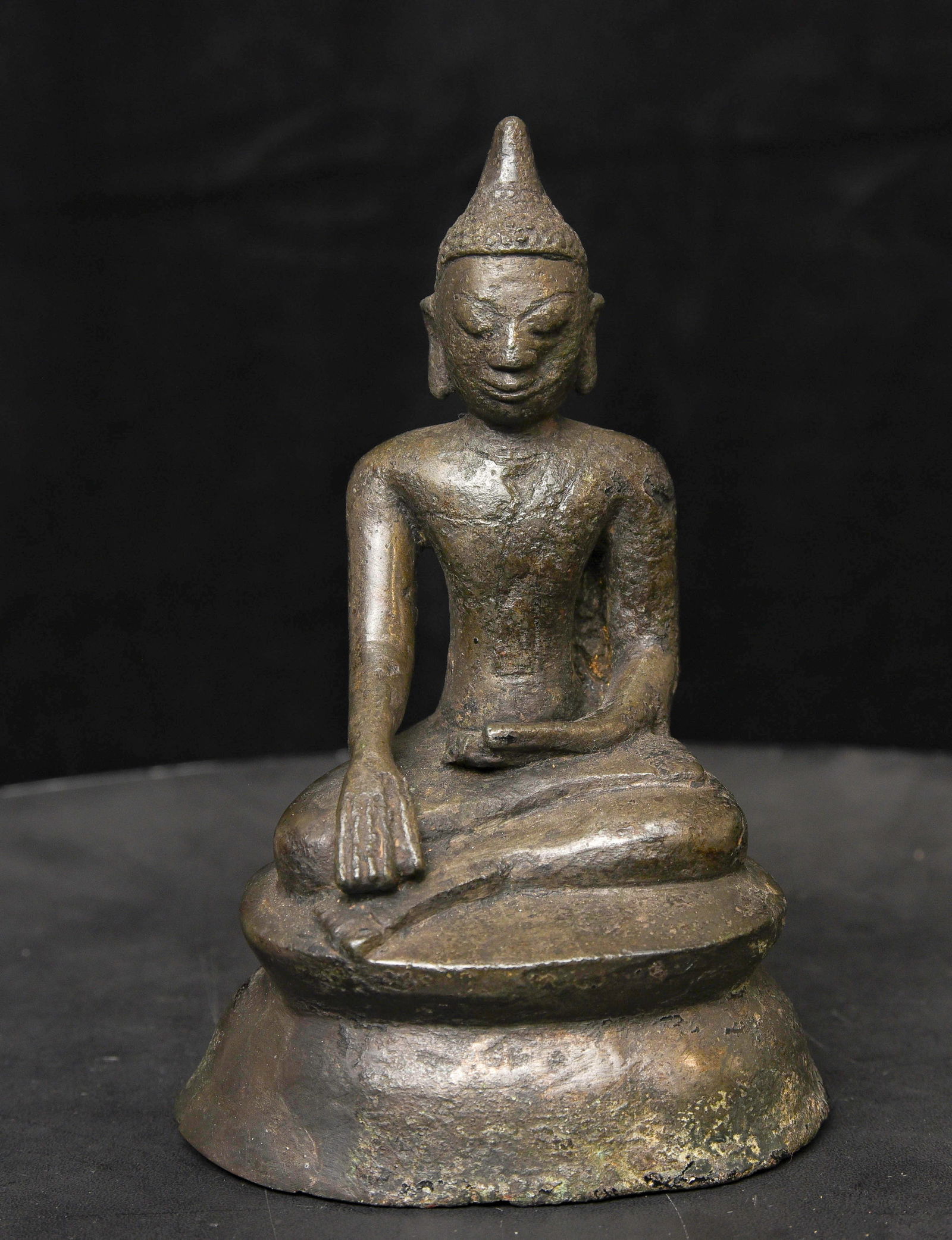 11-13thC Bronze Buddha - Unique, Burmese Mon . Very Rare Type: Burmese Mon Buddha. Hard to date, but probably 11 to 13 thc, maybe earlier. Sits 6 Inches Tall. One cheek is indented- it likely occurred during the casting process.
